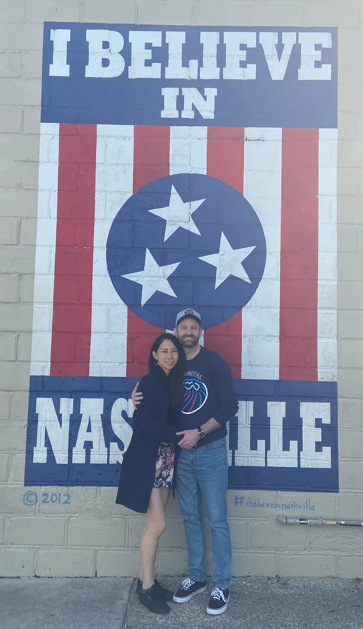 Brian and Shiori standing in front of the "I Believe in Nashville" mural in Nashville, Tennessee