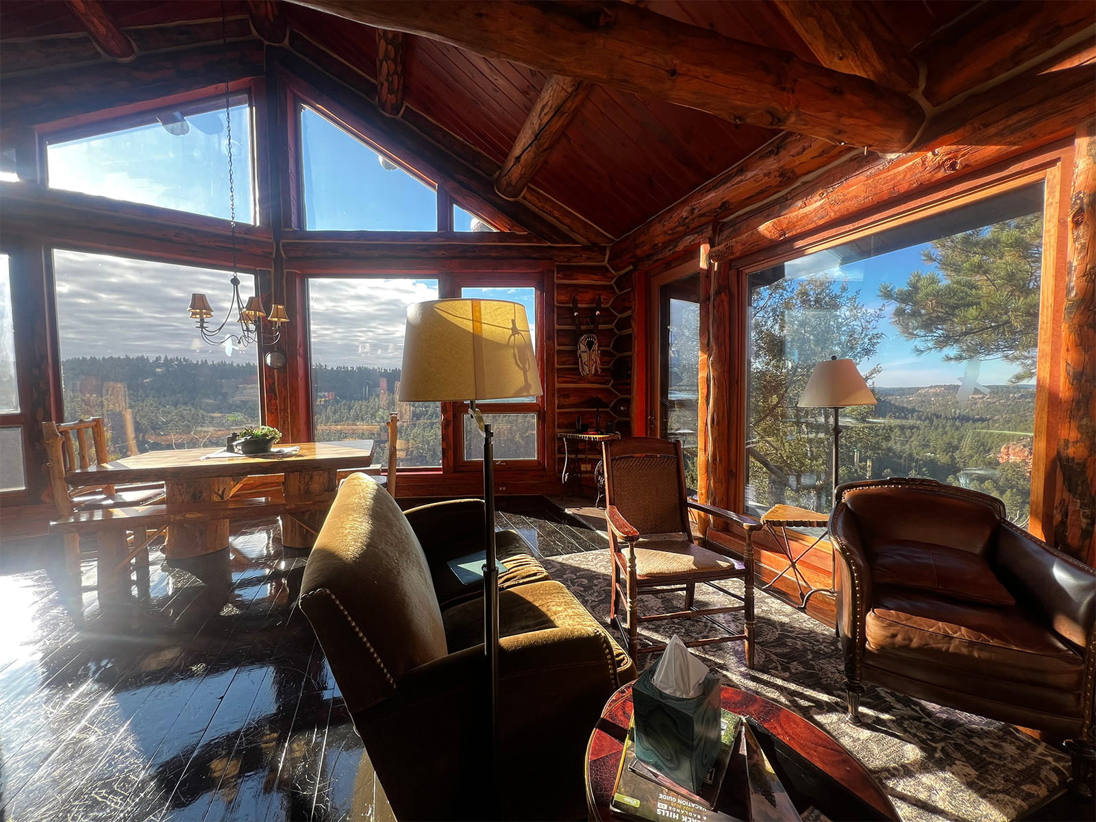 Glass-walled living room at a cliffside Airbnb, Red Canyon Ranch, South Dakota